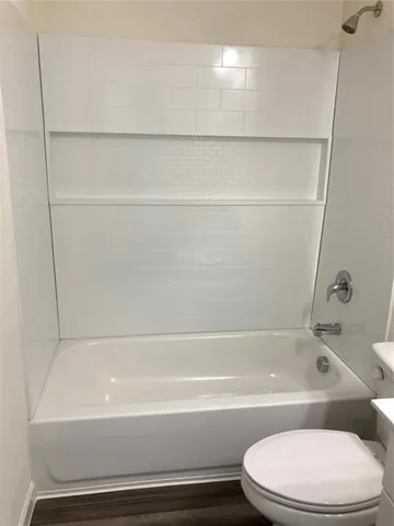 a bathroom with a bathtub and a toilet