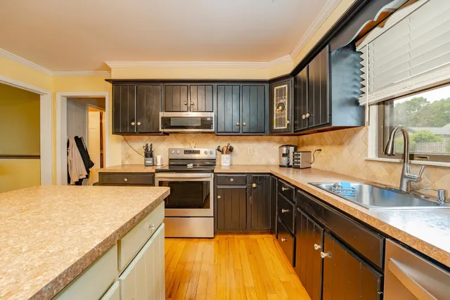 a kitchen with a sink stove and refrigerator