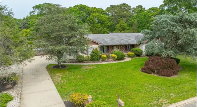a view of a house with a yard balcony and sitting area