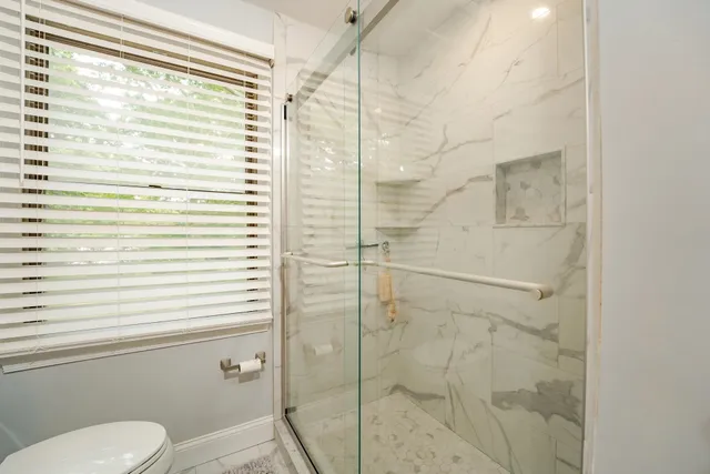 a bathroom with a toilet and shower