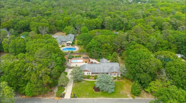 an aerial view of residential houses with outdoor space