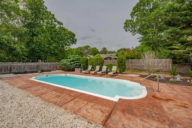 a view of a swimming pool with a yard
