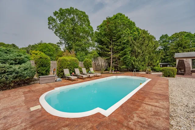 a view of a swimming pool with an outdoor space and seating area