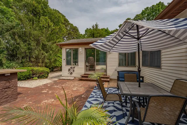 a view of a house with backyard and sitting area