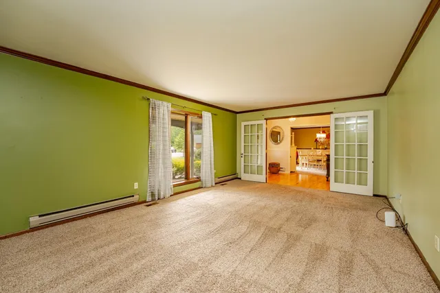 an empty room with floor to ceiling window