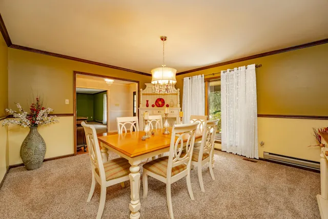 a dining room with furniture and window