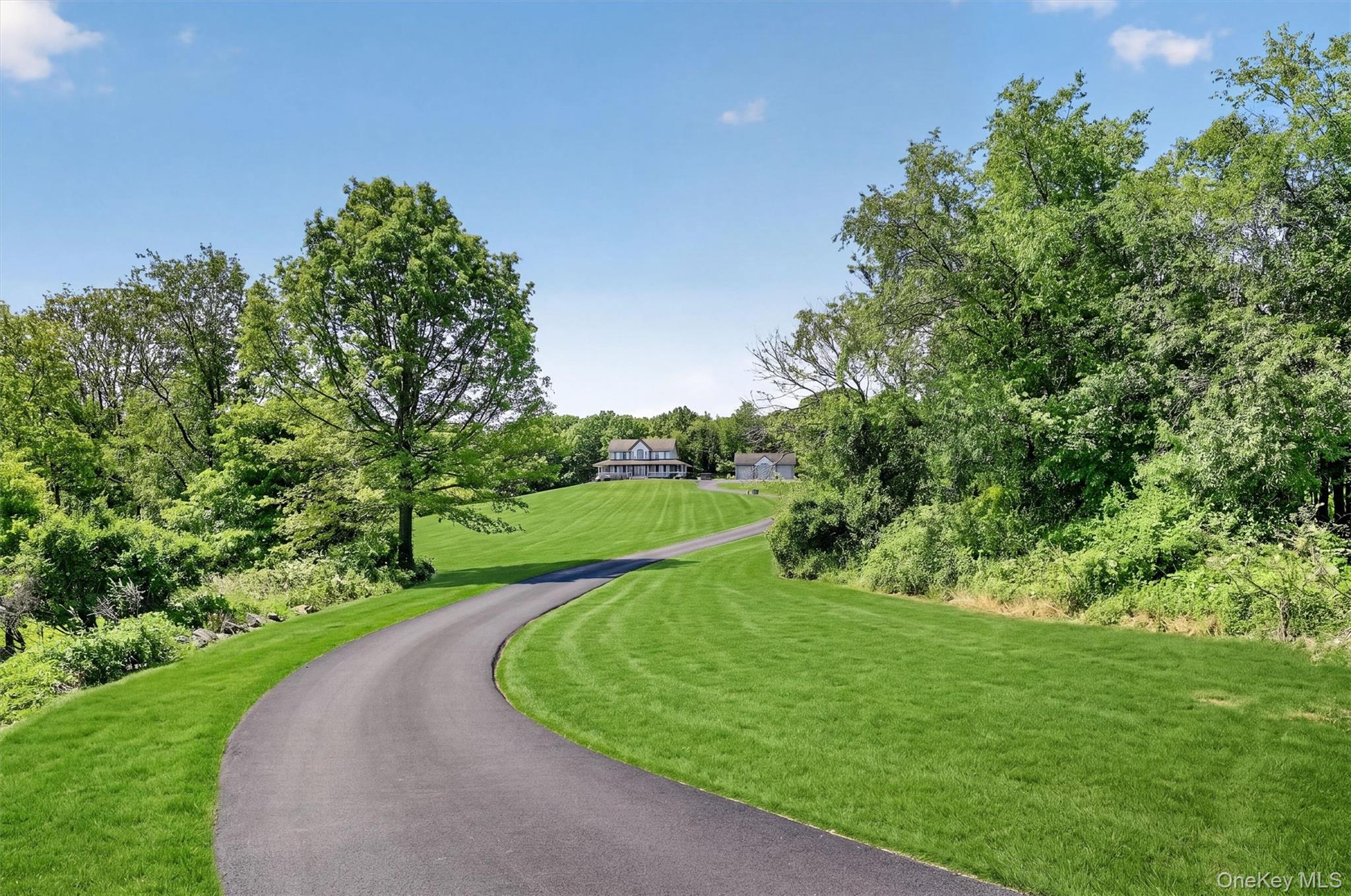 954 Ridgebury Road New Hampton, NY 10958 - Photo 43 of 45 The long private driveway creates a true sense of arrival, leading you through the green landscape toward a home tucked peacefully into its surroundings.