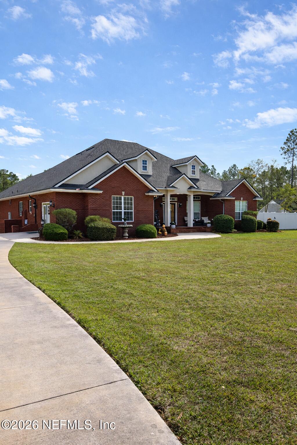 a front view of a house with a yard