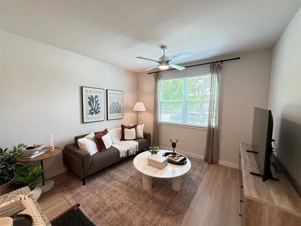 a bedroom with a bed couch and window