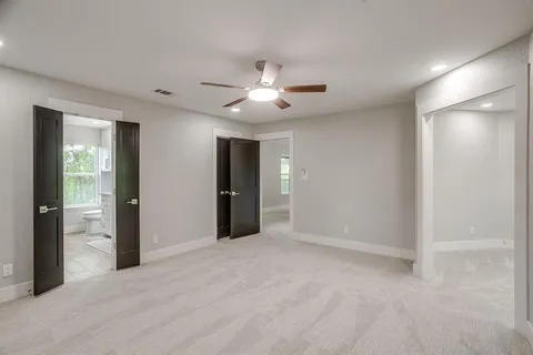 a view of an empty room with a ceiling fan