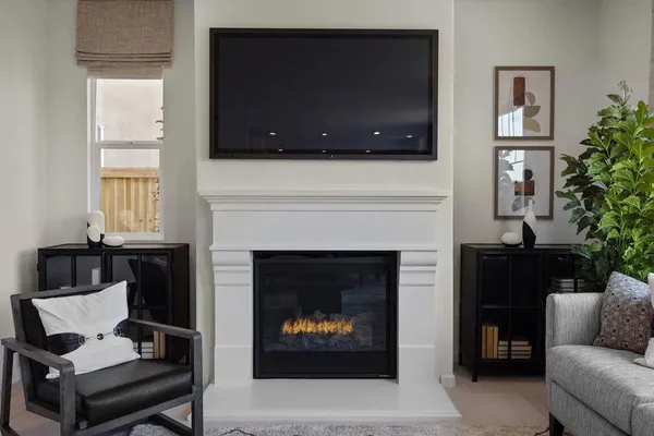 a living room with furniture a flat screen tv and a fireplace