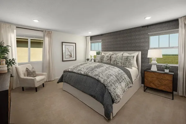 a spacious bedroom with a bed and glass window