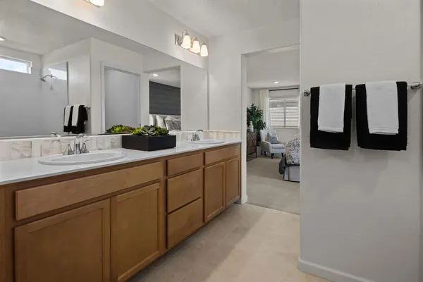 a bathroom with a double vanity sink and mirror