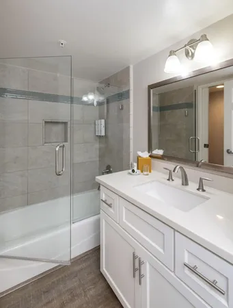 a kitchen with stainless steel appliances granite countertop a sink a stove a microwave a refrigerator and cabinets