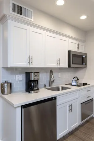 a living room with furniture and a mirror