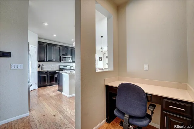 a bedroom with a bed a table and chair