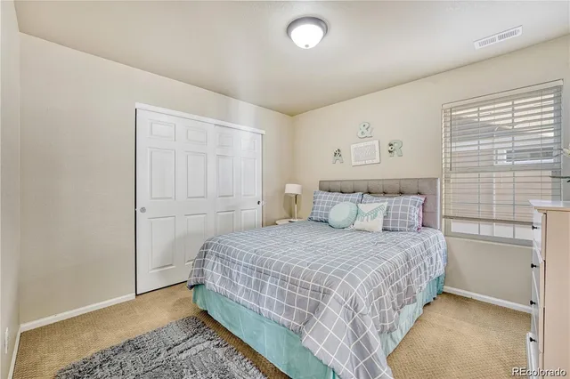 a bedroom with a bed and a lamp with window