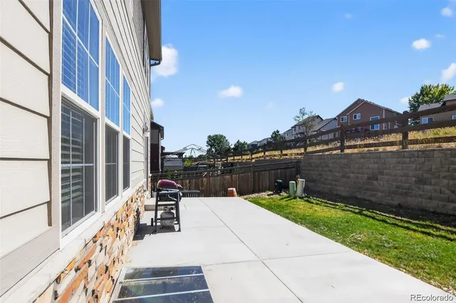 a backyard view of a house with a garden and entertaining space