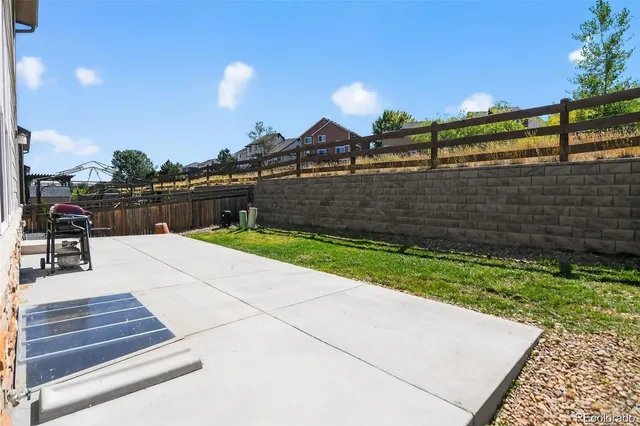 a view of a porch with a table and chairs