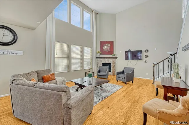 a living room with furniture fireplace and a window