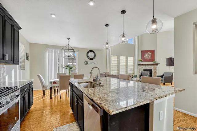 a kitchen with granite countertop kitchen island a table and chairs