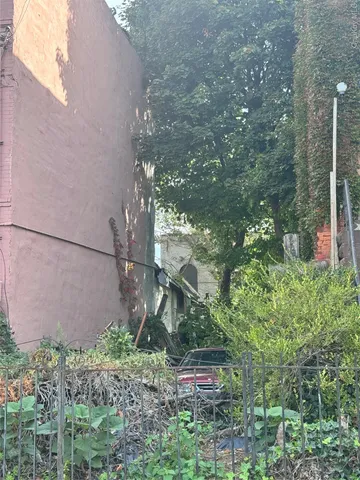 a backyard of a house with lots of green space and glass of water fountain