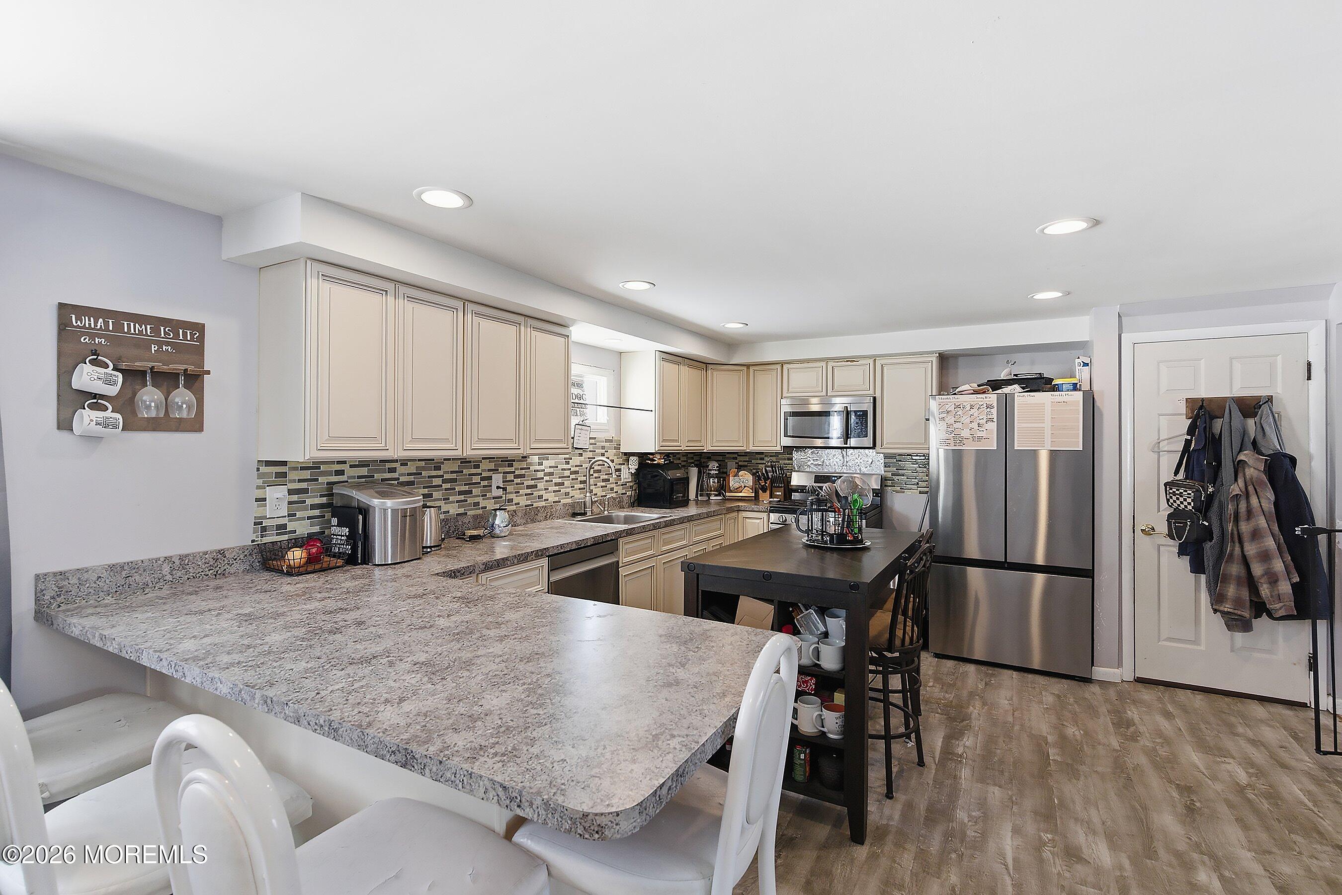 70 Oak Ridge Parkway Toms River, NJ 08755 - Photo 11 of 34 a kitchen with stainless steel appliances granite countertop a refrigerator and a sink