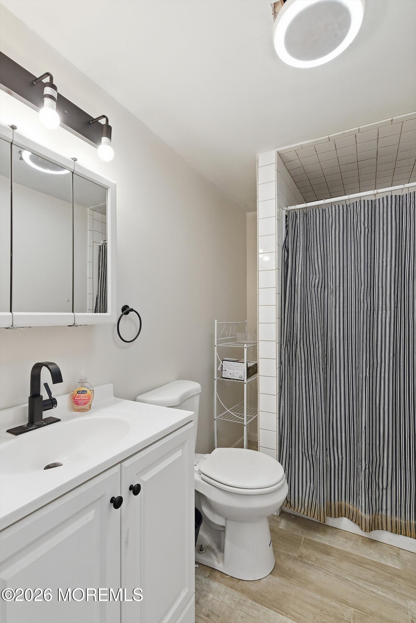 70 Oak Ridge Parkway Toms River, NJ 08755 - Photo 12 of 34 a bathroom with a toilet sink and shower