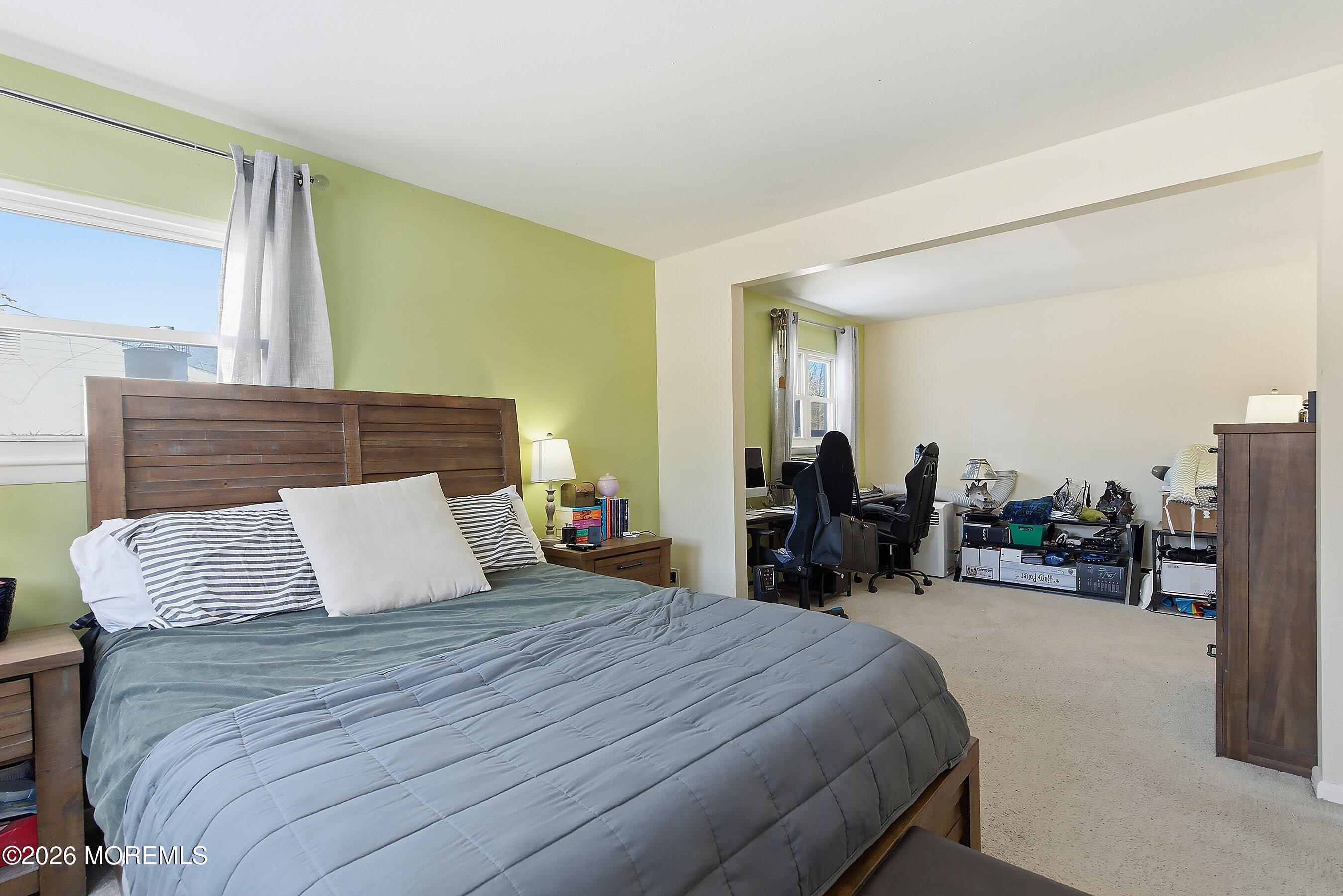 70 Oak Ridge Parkway Toms River, NJ 08755 - Photo 16 of 34 a bedroom with a bed and a mirror