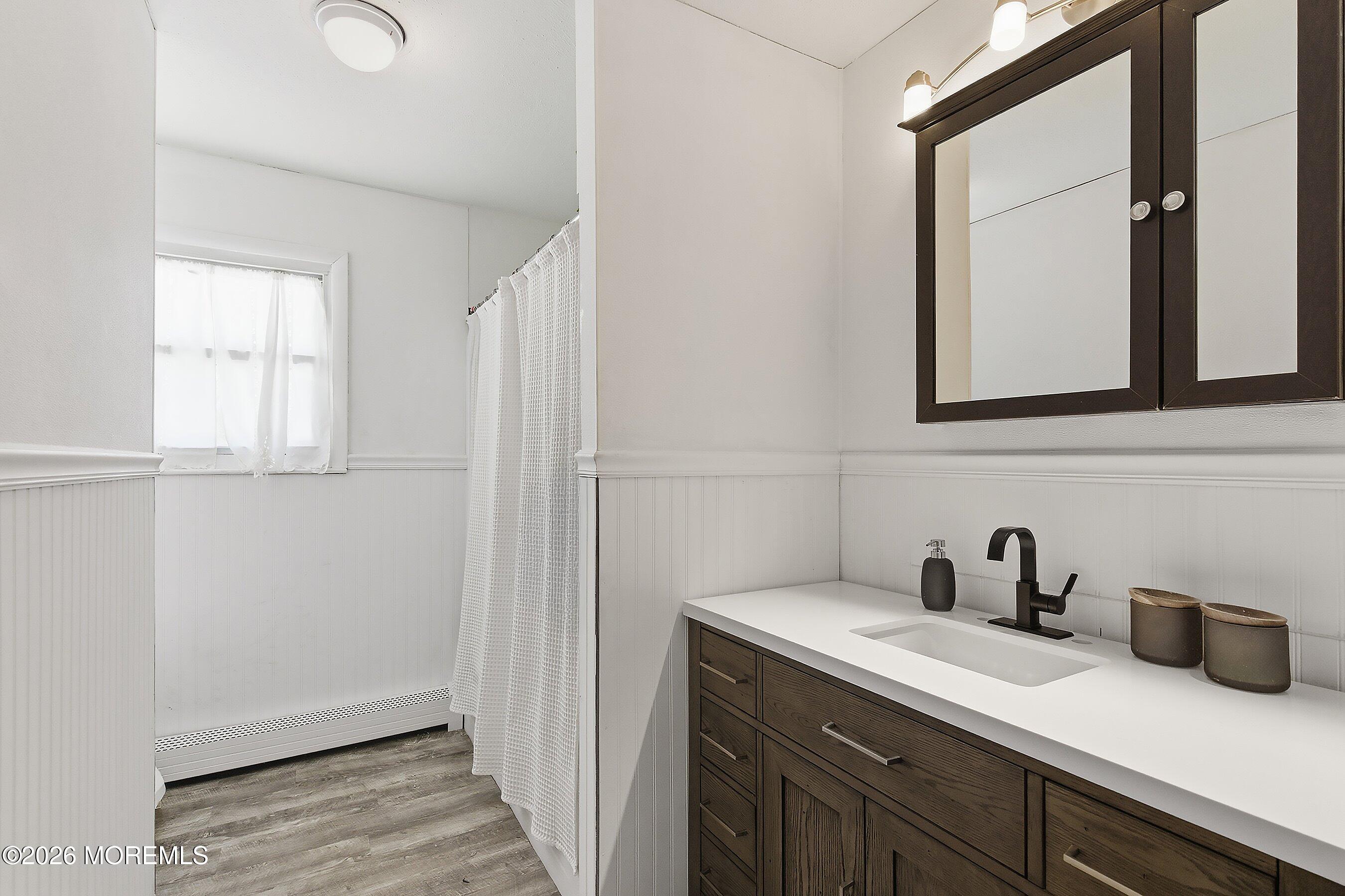 70 Oak Ridge Parkway Toms River, NJ 08755 - Photo 21 of 34 a bathroom with a sink a mirror and cabinets