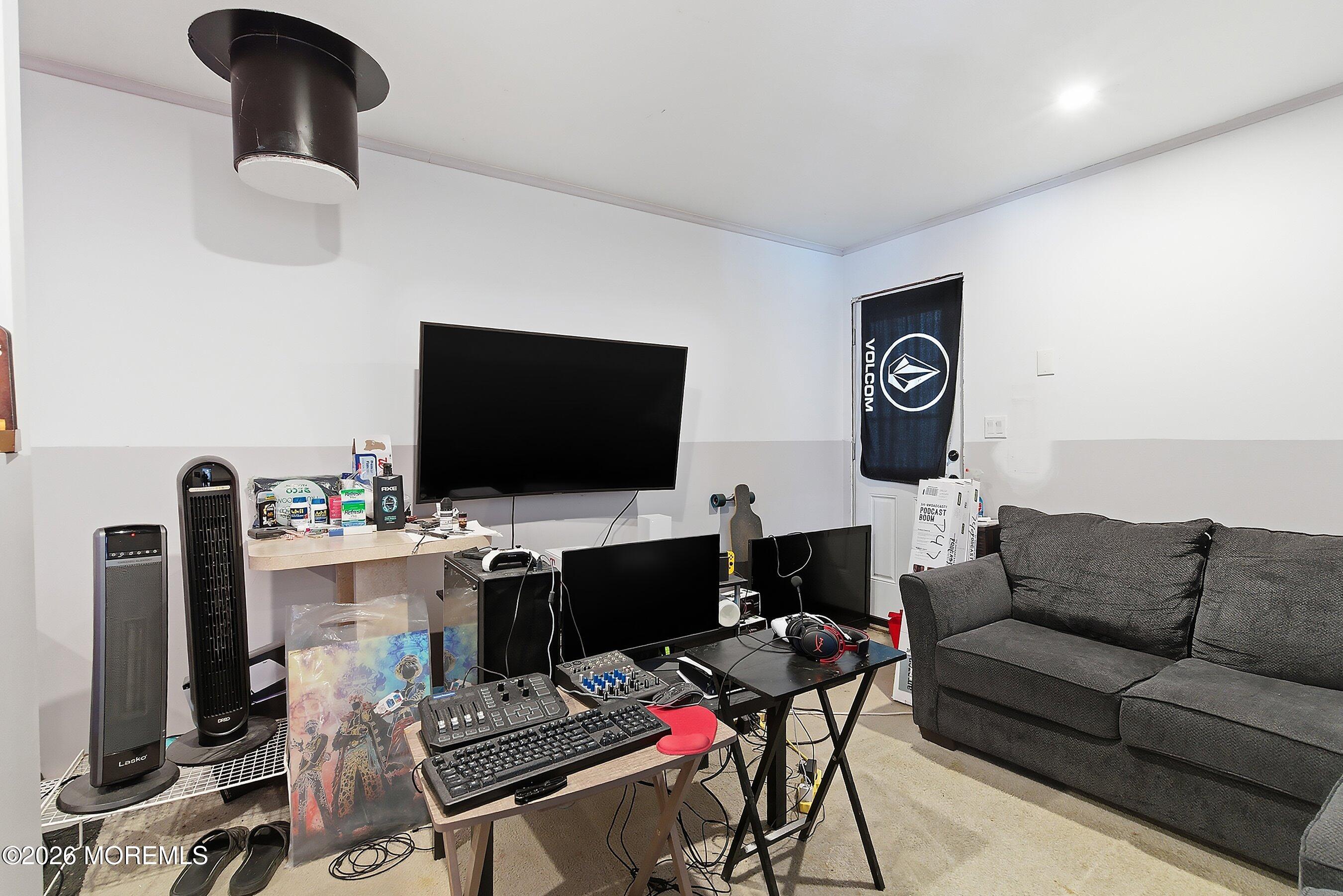 70 Oak Ridge Parkway Toms River, NJ 08755 - Photo 23 of 34 a living room with furniture and a flat screen tv