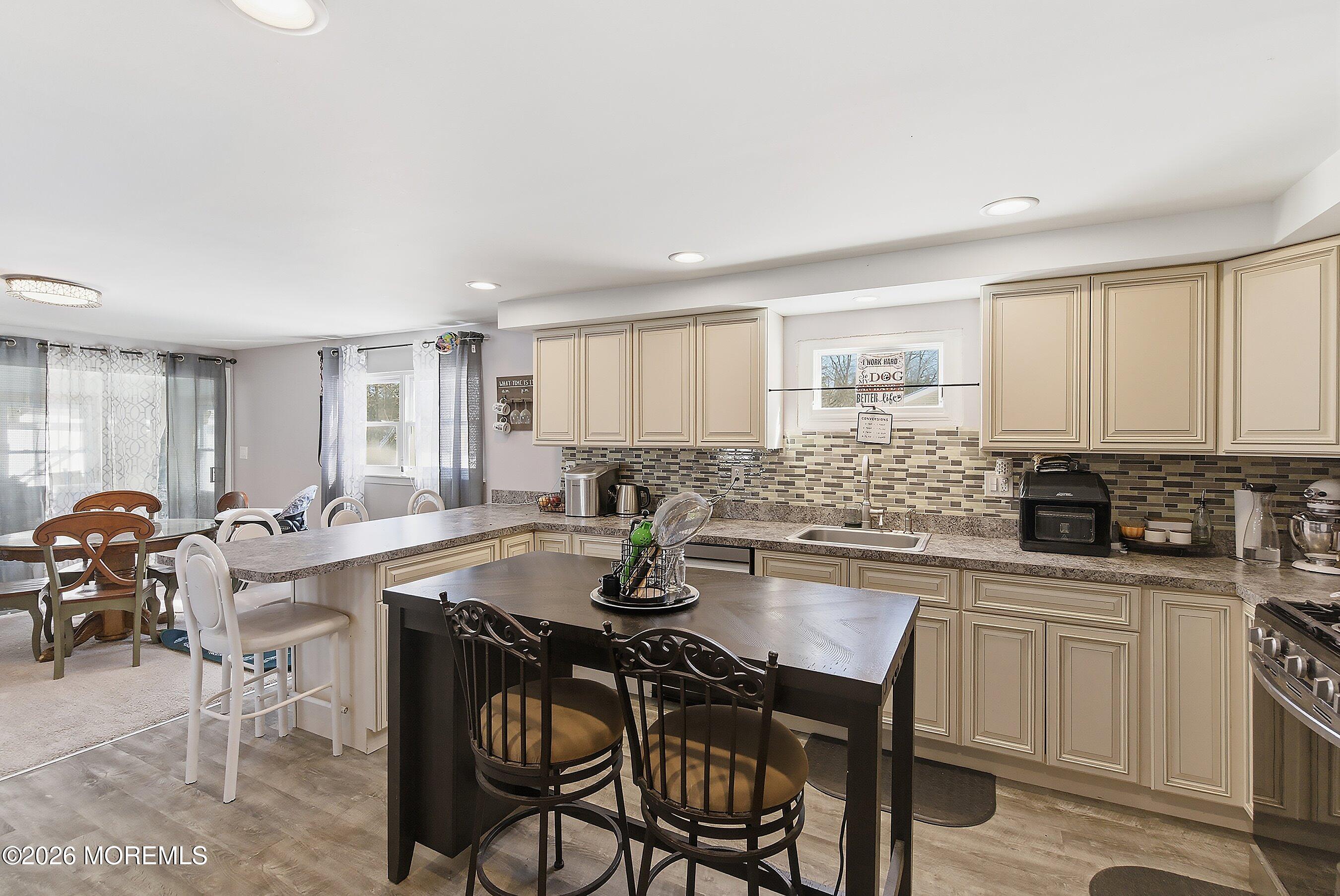 70 Oak Ridge Parkway Toms River, NJ 08755 - Photo 7 of 34 a kitchen with a table chairs stove and cabinets