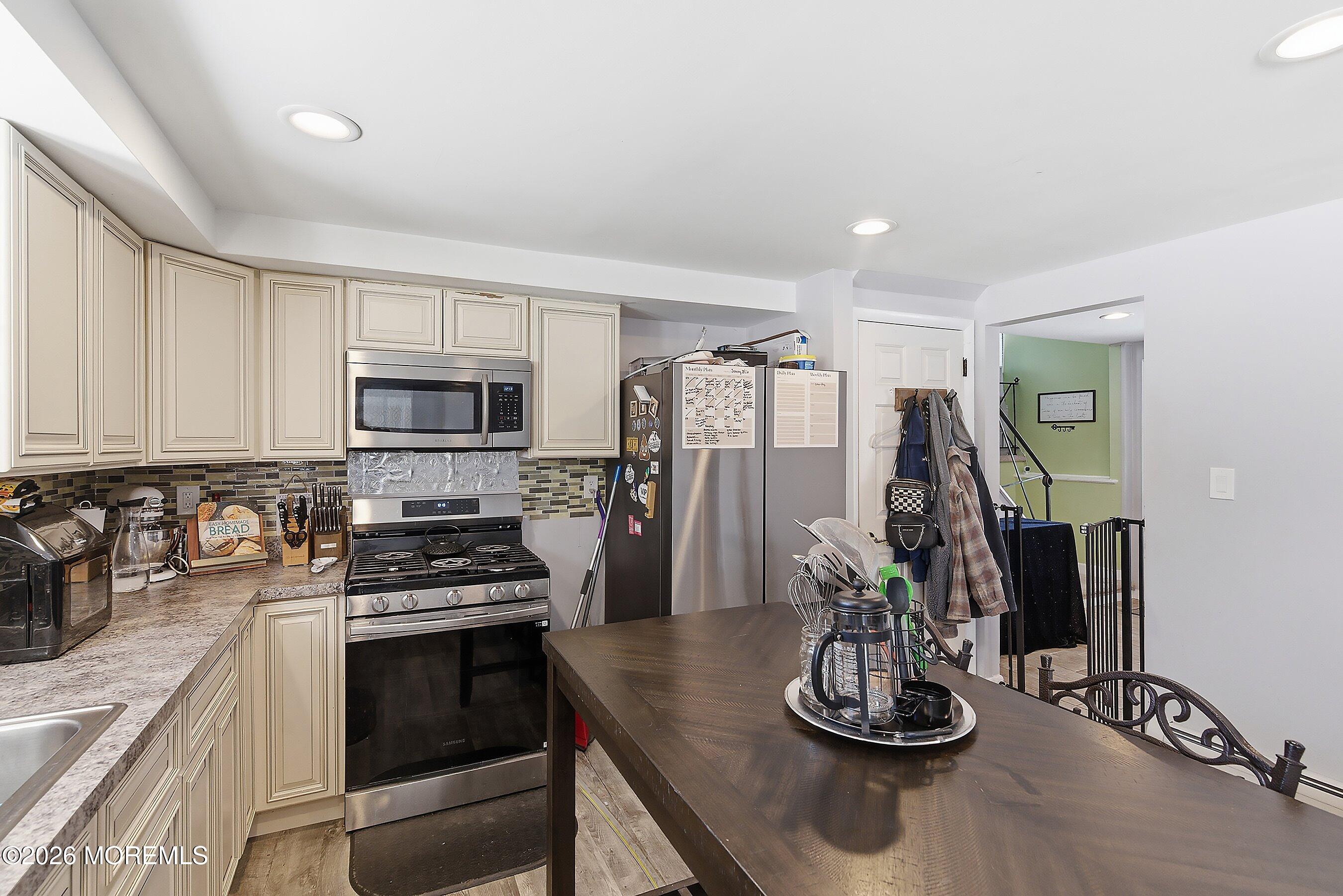 70 Oak Ridge Parkway Toms River, NJ 08755 - Photo 8 of 34 a kitchen with stainless steel appliances kitchen island granite countertop a refrigerator and a sink