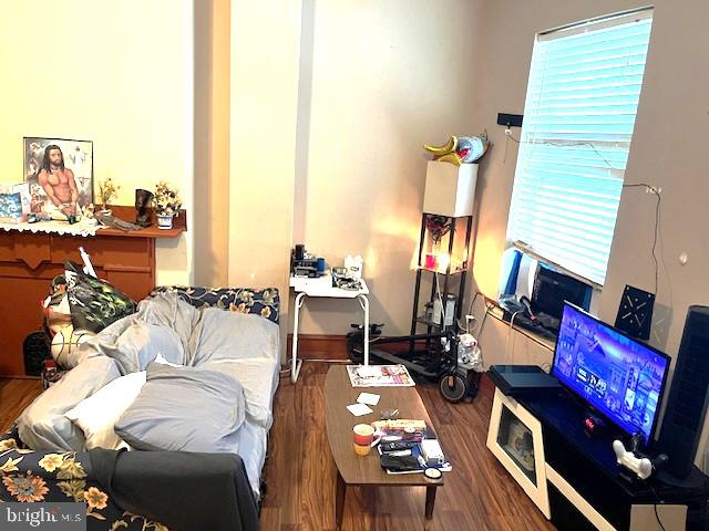 912 Point Street Camden, NJ 08102 - Photo 6 of 10 a living room with furniture a rug and a floor to ceiling window