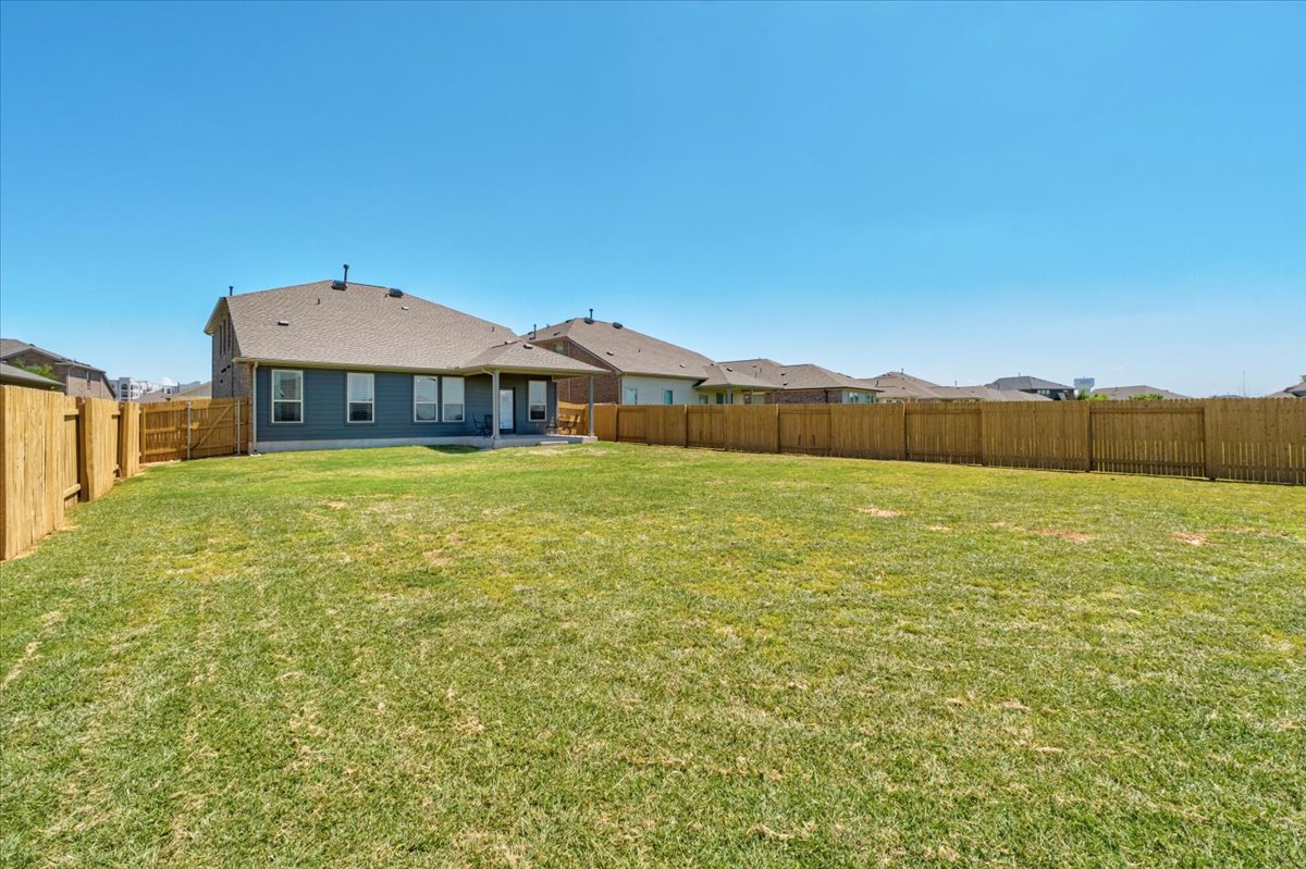 5408 Vanner Path Georgetown, TX 78626 - Photo 33 of 34 Expansive green lawn with full wood privacy fencing
