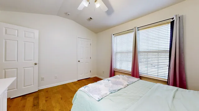 a bedroom with a bed and a window