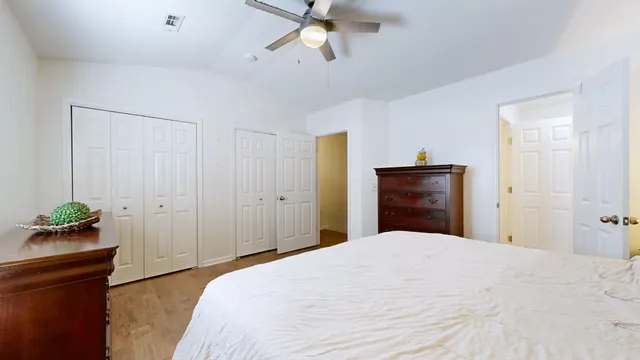 a bedroom with a bed and a dresser