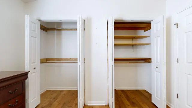 a view of walk in closet with empty racks