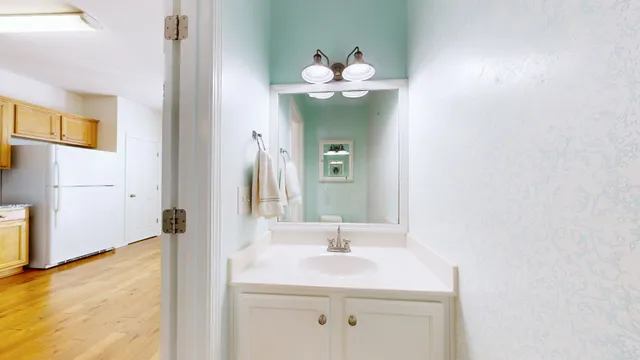 a bathroom with a sink mirror and vanity