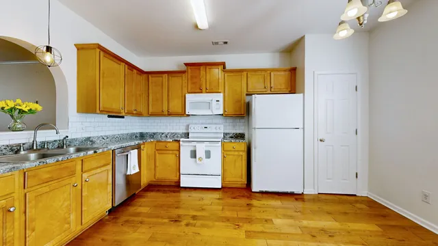 a kitchen with cabinets a sink and appliances