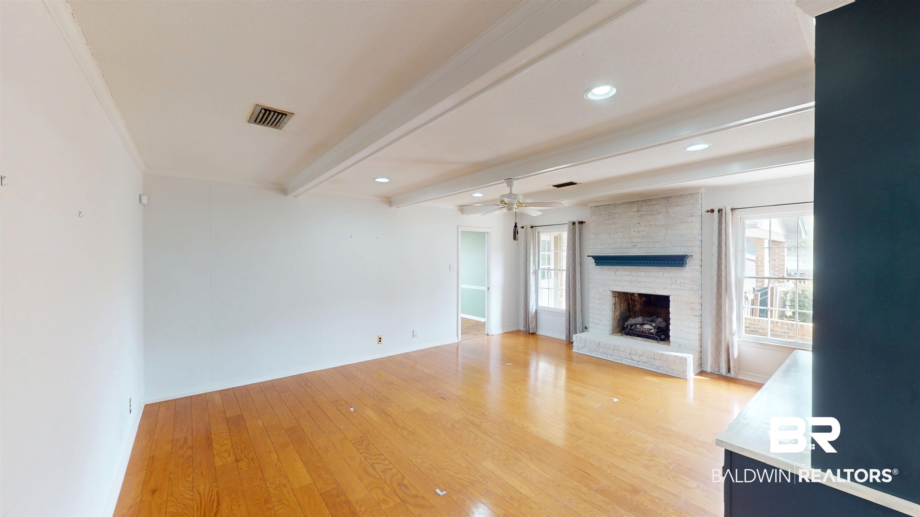 609 Burlington Court Mobile, AL 36608 - Photo 10 of 19 Unfurnished living room with beamed ceiling, light wood-style flooring, a fireplace, ceiling fan, and recessed lighting
