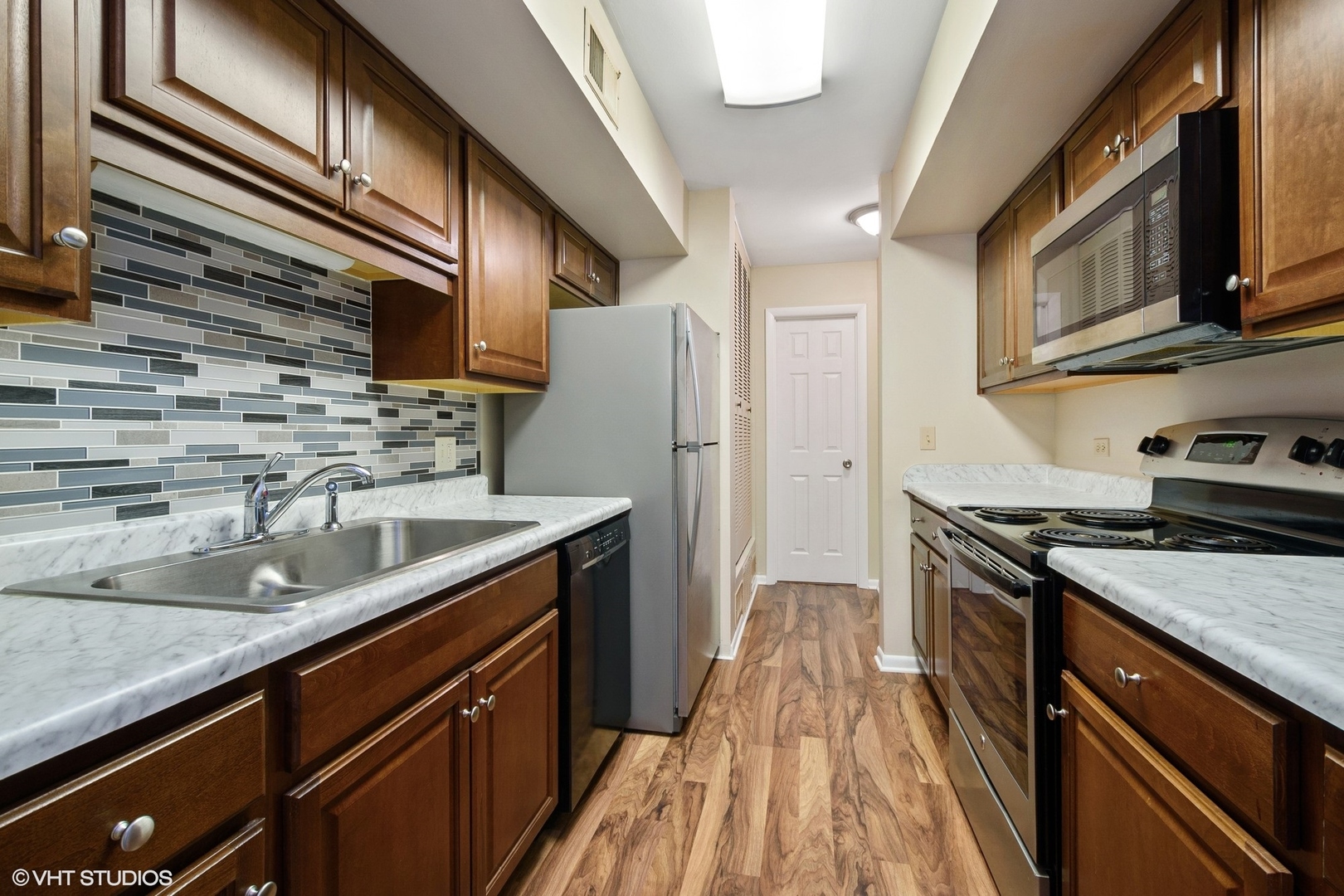 520 Shorely Drive, Unit 201 Barrington, IL 60010 - Photo 5 of 12 a kitchen with stainless steel appliances granite countertop a sink a stove and a refrigerator