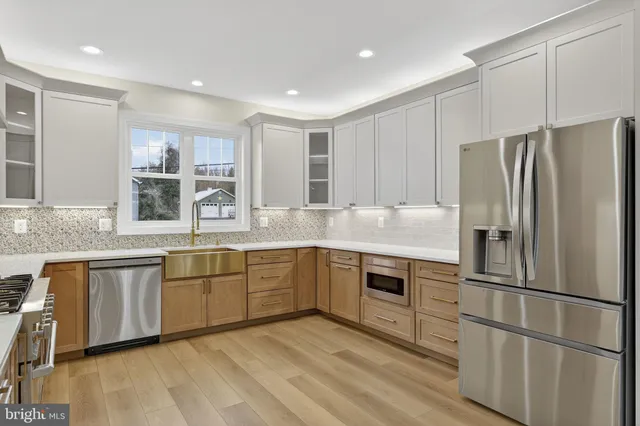 a kitchen with stainless steel appliances granite countertop a refrigerator sink and cabinets