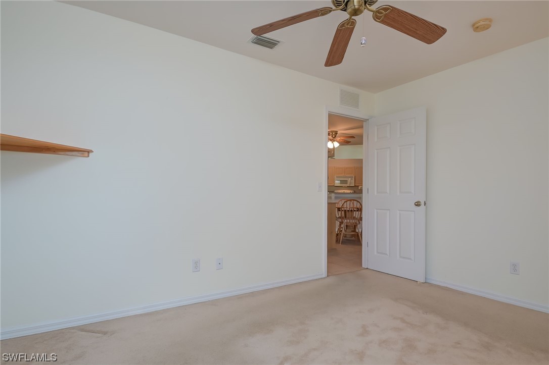 819 Rue Labeau Circle Fort Myers, FL 33913 - Photo 14 of 31 an empty room with closet and fan