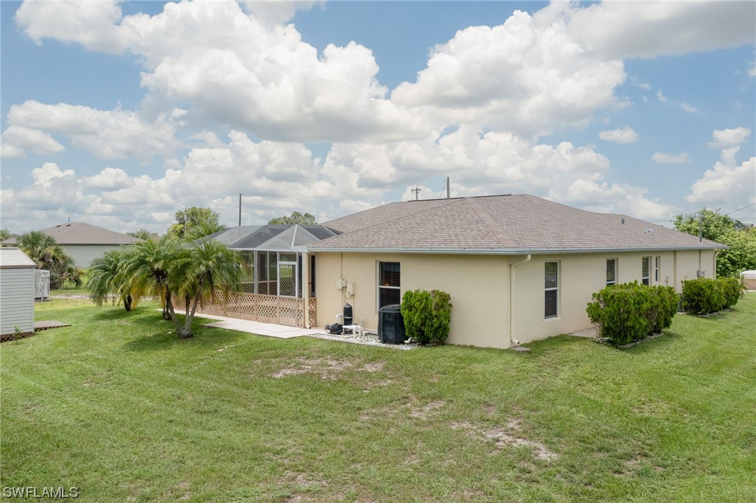 819 Rue Labeau Circle Fort Myers, FL 33913 - Photo 29 of 31 a view of a white house with a big yard and potted plants