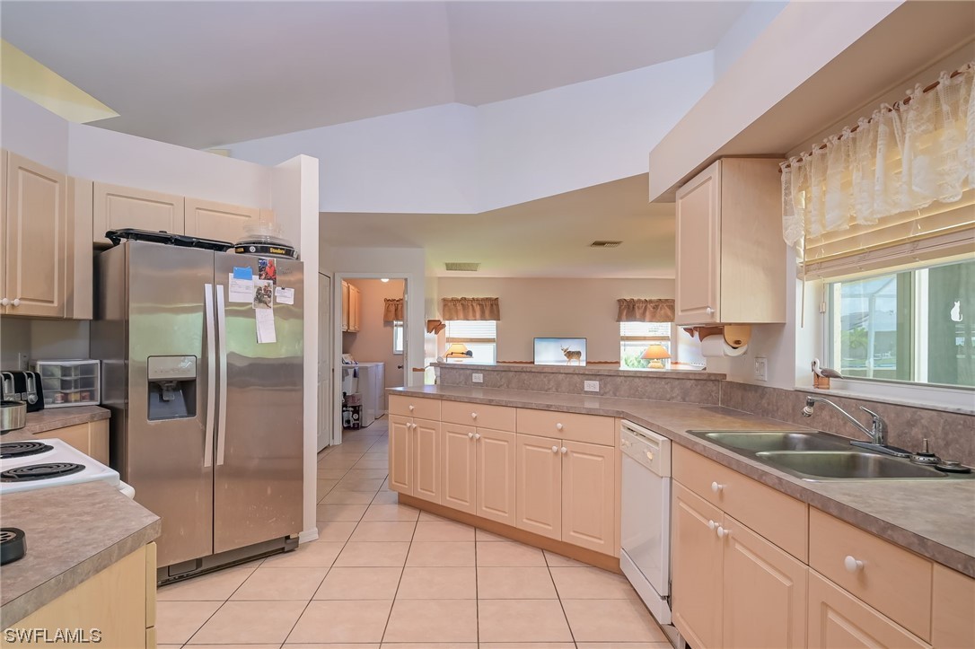 819 Rue Labeau Circle Fort Myers, FL 33913 - Photo 7 of 31 a kitchen with stainless steel appliances granite countertop a sink and cabinets