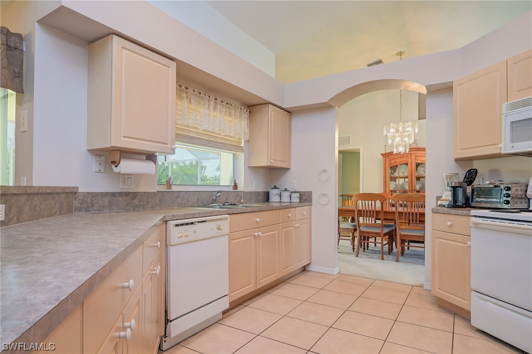 819 Rue Labeau Circle Fort Myers, FL 33913 - Photo 8 of 31 a kitchen with cabinets appliances and a window