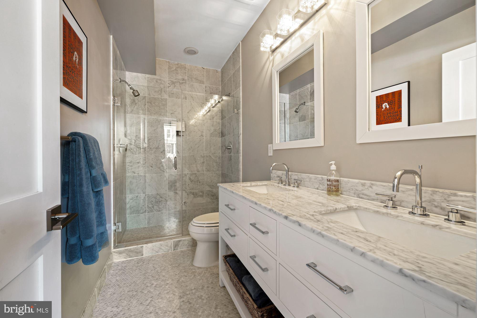 217 Randolph Place Northeast, Unit 1 Washington, DC 20002 - Photo 22 of 26 Main bathroom with marble flooring & double vanity