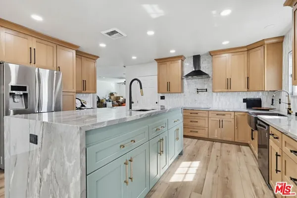 a kitchen with stainless steel appliances sink refrigerator microwave and cabinets