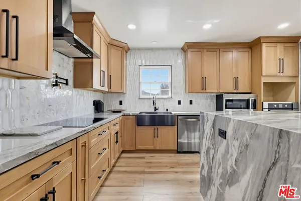 a kitchen with stainless steel appliances granite countertop a stove and a sink